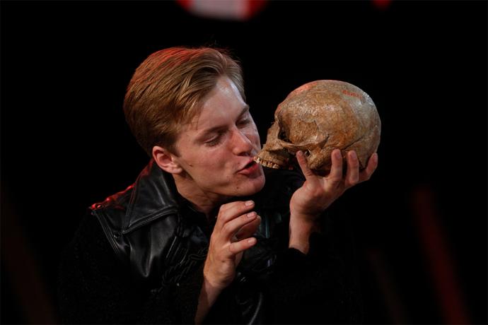 a photo of a man holding a skull