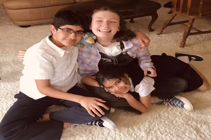 3 kids from the Jedo's Dead cast are huddled together and smiling at the camera