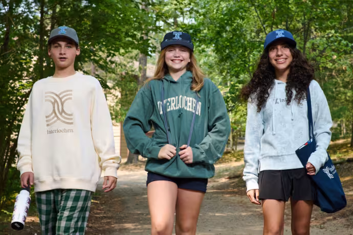 Interlochen Arts Camp students walk toward the camera