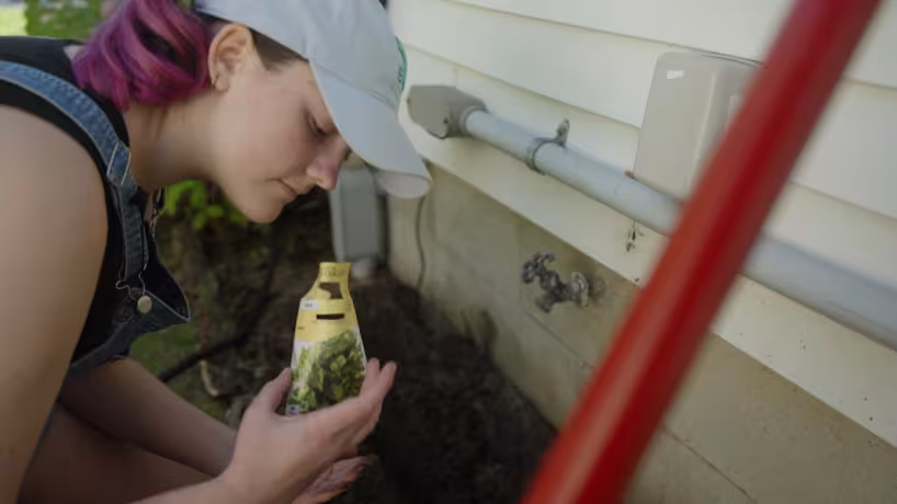 Arts Academy student plants seeds during the Greenacres Grounded production