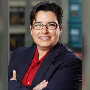 A professional headshot of a woman