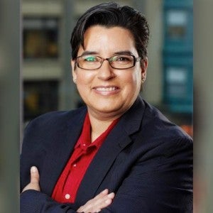 A professional headshot of a woman