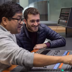 A teacher and student work with a digital audio interface