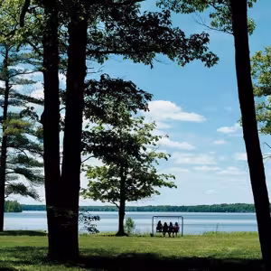 Intermediate girls sit on a swing near Green Lake