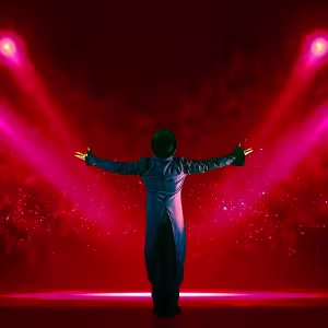 Man on stage with red lights