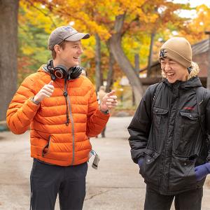 Two Interlochen Arts Academy share a laugh while walking on Osterlin Mall.