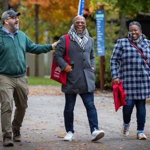 Three alumni stroll on campus during the Fall 2022 Interlochen Arts Academy Reunion.
