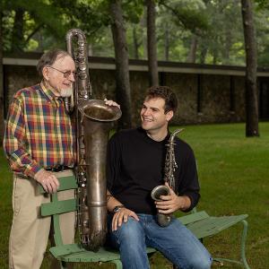 Jake Goldwasser and John Beery pose with two vintage saxophones.