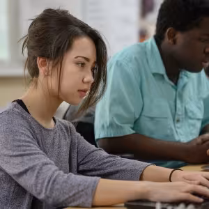 A student works on a laptop in class.