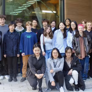A group of students and teachers poses outside Interlochen's Music building.