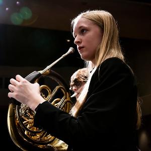 Arts Academy horn student Sydney Richardson rehearses with the IAA Wind Symphony