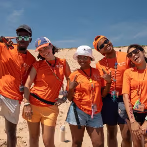 Interlochen Arts Camp Life staff smile for the camera at the sand dunes