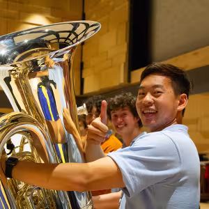 Interlochen Arts Camp students smile for the camera during a pause in rehearsal.