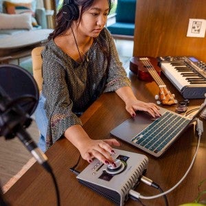 A student works on a computer with a Digital Audio Workstation.