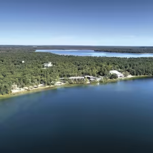 Aerial shot of Interlochen's campus showing the two lakes and pine forests