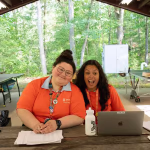 Two Camp counselors prepare to welcome students to Institutes week. 