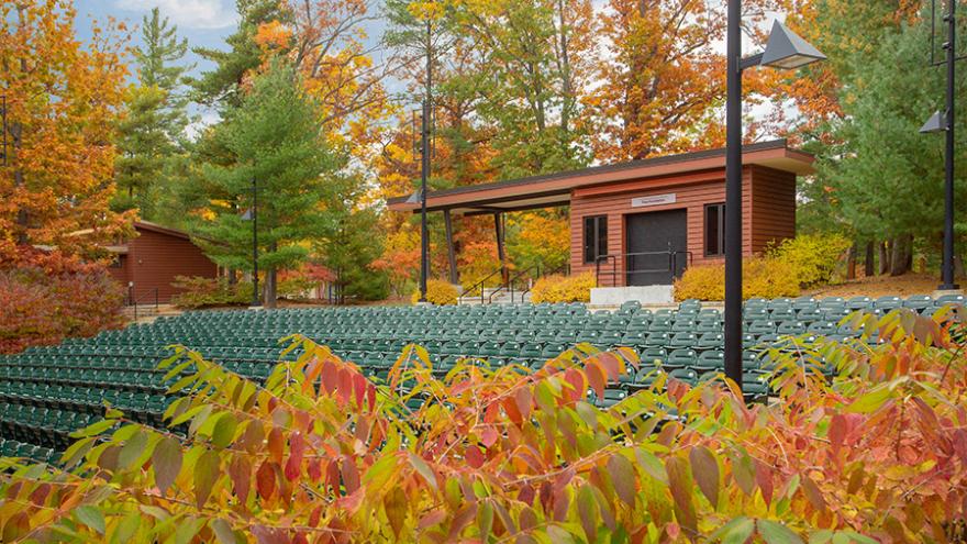 An outdoor amphitheater ablaze with fall color